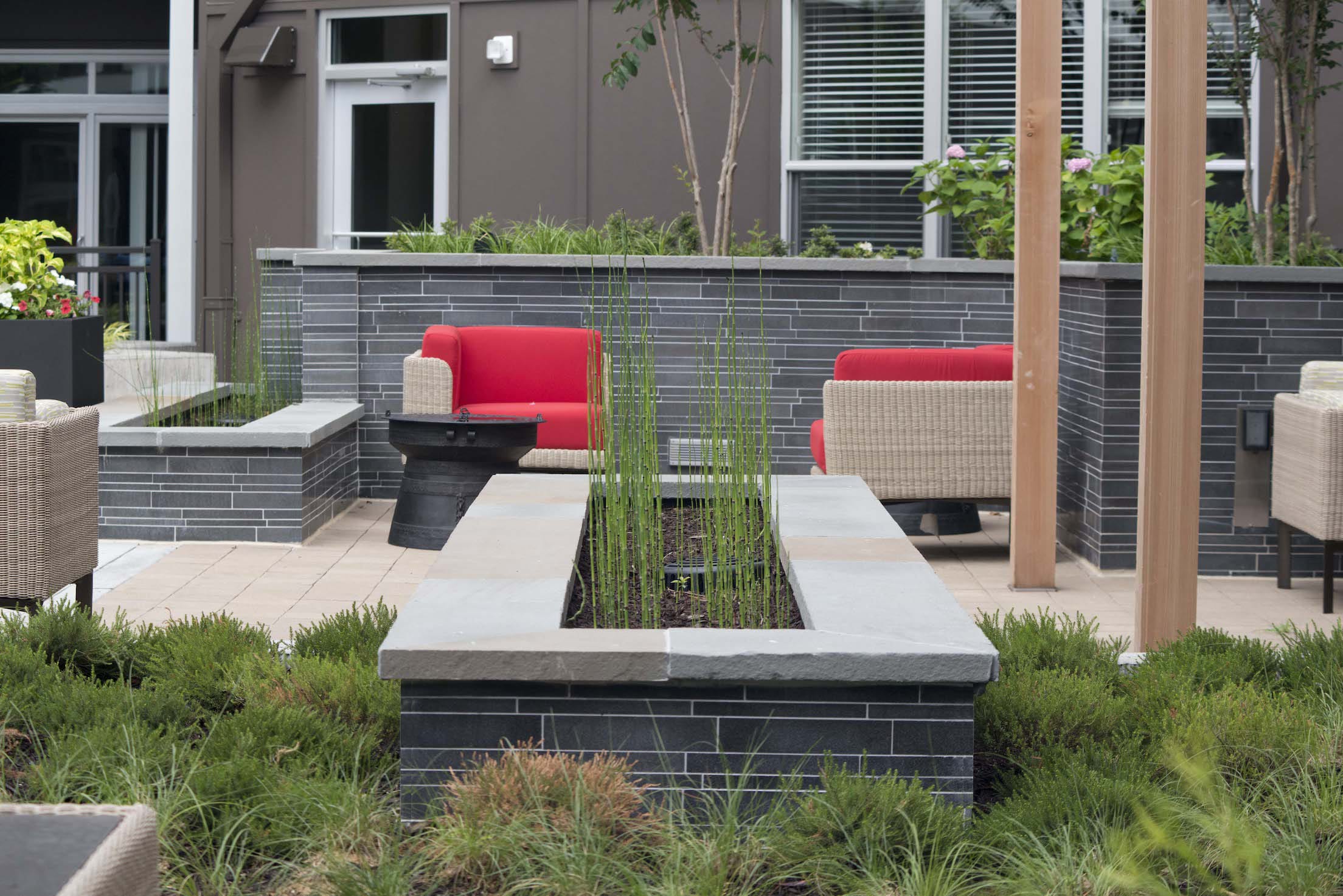 Norstone Grey Basalt Interlocking Tiles used on a multi level landscape planter wall